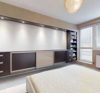 Bright bedroom with a built-in wardrobe and a large window in a 4-room apartment.