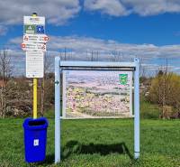 Information board with a map and a bin in the village of Sap near family houses.