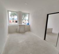 A spacious room under renovation inside a 3-room apartment with large windows.