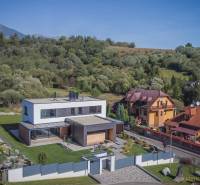 A family house on Tatranská in Nová Lesná surrounded by greenery and neighboring houses.