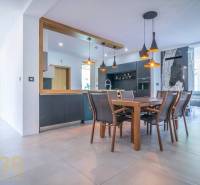 A dining room in a family house with stylish wooden furniture and lighting.