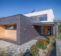 A family house on Tatranská Street in Nová Lesná with wooden cladding and a garden.