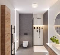Bathroom in a holiday apartment with a modern shower and wooden storage furniture.