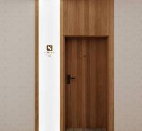 Bright interior of a holiday apartment with wooden doors and geometric wallpaper.