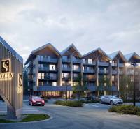 A recreational apartment in Štôla with modern architecture and an illuminated entrance in an evening setting.