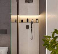 Shower enclosure in a holiday apartment with lighting and a shower head.