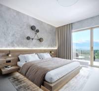 Elegant bedroom in a holiday apartment with a wooden bed and mountain view.