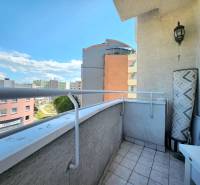 A balcony with tiles and a view of apartment buildings in Karlova Ves on Cikkerova Street.