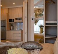 A 2-room apartment with a kitchen, living room, and decorations, offers a view into the main area.