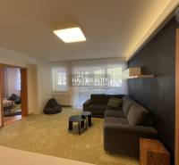 Living room in a 3-room apartment with a sofa, light walls, and a black accent.