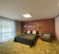 A stylish bedroom in a 3-room apartment with a large window and a comfortable bed.