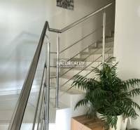 Interior of a 3-room apartment with white stairs and stainless steel railing.