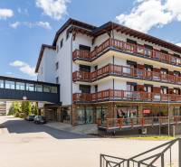 Apartment complex in Donovaly with balconies and connecting bridge.