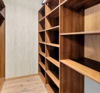 A wardrobe with wooden shelves in a 3-room apartment, suitable for storing clothes.