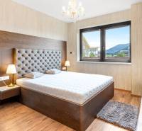 Bedroom with a comfortable bed in a 3-room apartment, light walls, and a view.