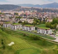 View from Karpatská Street in Trenčín of residential buildings with a golf course.