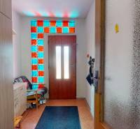 Entrance hallway with colored glazing and wooden doors in a family house.