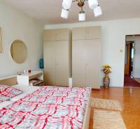 Bedroom in a family house with a double bed, wardrobes, and hallway space.