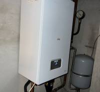 Gas boiler in the utility room of a family house, including pipes and a pressure vessel.