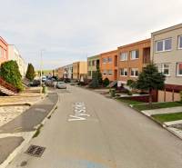 Vysoká Street in Holíč with terraced houses and parked cars.