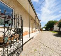 A family house on Milhostovská Street in Trebišov with a wrought iron gate and a landscaped entrance.