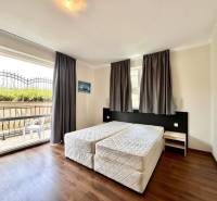 A recreational apartment with a double bed and a balcony, providing privacy and comfort.