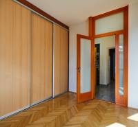 A room with a built-in wardrobe and wooden doors in a 4-room apartment.