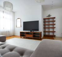 Living room in a 4-room apartment with a TV, sofa, and fireplace.