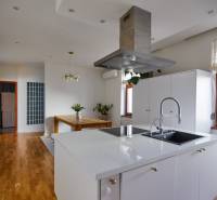 A kitchen with a stylish island and a dining table in a 4-room apartment.