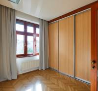 A room with a built-in wardrobe, wooden floors, and a large window in a 4-room apartment.