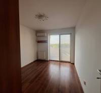 A room with a wooden floor and built-in air conditioning in a 3-room apartment.