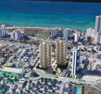 A view of the beach resort and residential buildings in the city of Calp with a sea view.