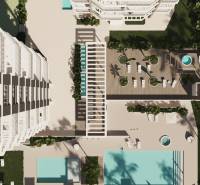 A view from above of the terrace with pools and loungers at a 3-bedroom apartment in Calpe.