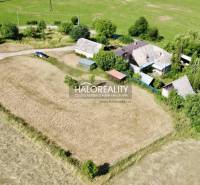A family house in Ploské surrounded by nature, fields, and greenery.