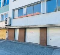 Garages on Štefánik Square in Spišská Nová Ves with entrances and an advertising board.