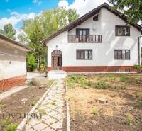 A family house in Žihárec with a white facade, a veranda, and a garden.
