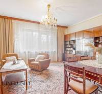 Living room of a family house with a chandelier, carpet, and wooden furniture, cozy atmosphere.