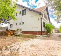 A family house in Žihárec with a landscaped garden and a paved driveway.