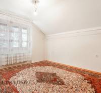 Interior of a family house with a carpet and a window, light walls and floors.