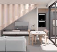 The interior of a family house with an open layout, where the kitchen and living room dominate.