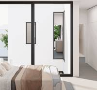 A bright bedroom in a family house with sliding doors and a view of greenery.