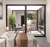Bedroom in a family house with a view of the terrace and garden furniture.