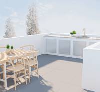 There is a terrace with wooden furniture and an outdoor kitchen in the family house.