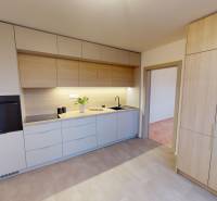 A kitchen in a 3-room apartment with wooden cabinets and appliances.
