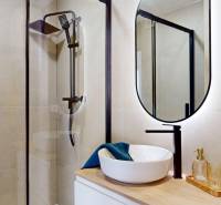 Bathroom with a shower and a mirror in a 3-room apartment, elegant details and design.
