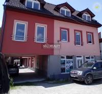 Commercial premises in Brezno with multiple windows, parked cars in front of the building.