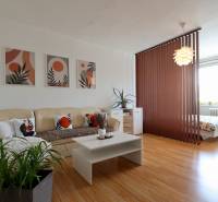 Living room with a sofa, table, and placement of a painting in a 2-room apartment.