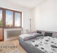 A room in a family house with a bed, a window, and a radiator.