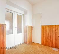 Wooden cladding and light doors in the interior of a family house.