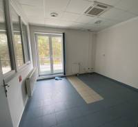 An empty room with a tiled floor, windows, radiator, air conditioning, warehouses, and halls.